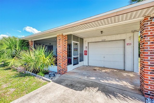 doorway to property with a garage