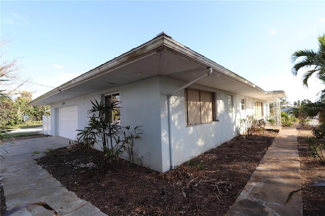 view of side of home featuring a garage