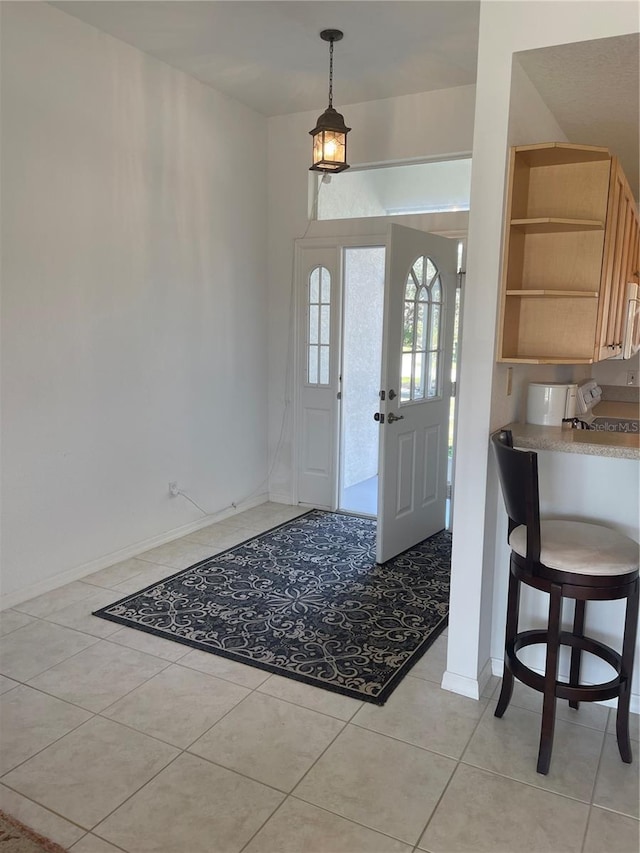 foyer entrance featuring light tile patterned flooring