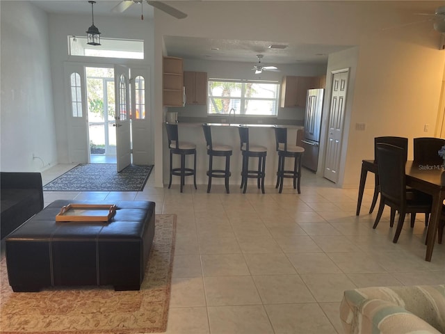 tiled living room featuring sink and ceiling fan