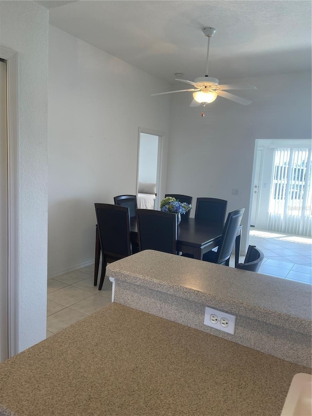 dining area with light tile patterned flooring and ceiling fan