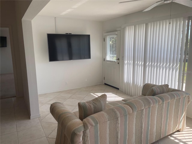 living room featuring light tile patterned floors and ceiling fan