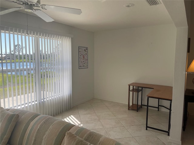 interior space with ceiling fan and a water view