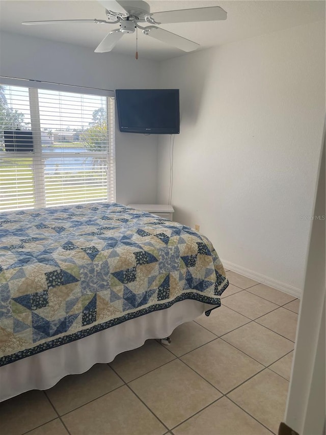 bedroom with light tile patterned floors and ceiling fan