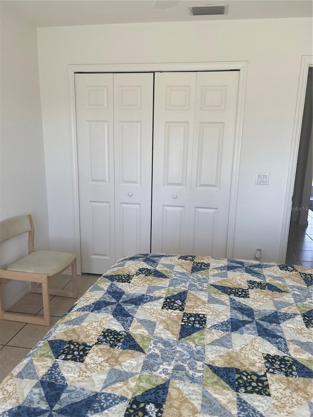 tiled bedroom featuring a closet