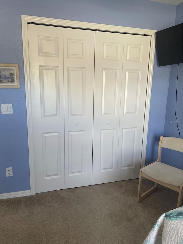 unfurnished bedroom with carpet flooring and a closet