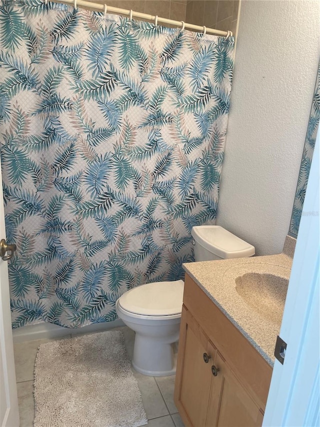 bathroom with vanity, toilet, and tile patterned flooring