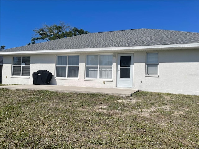 back of property with a patio area and a lawn