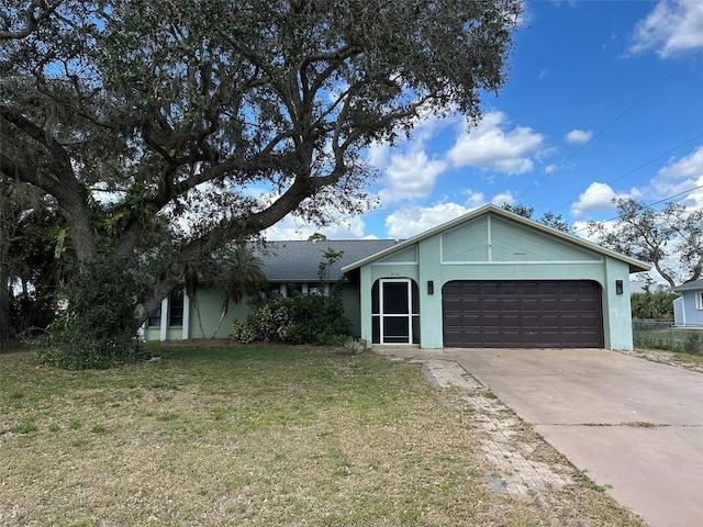 ranch-style home featuring a garage and a front lawn