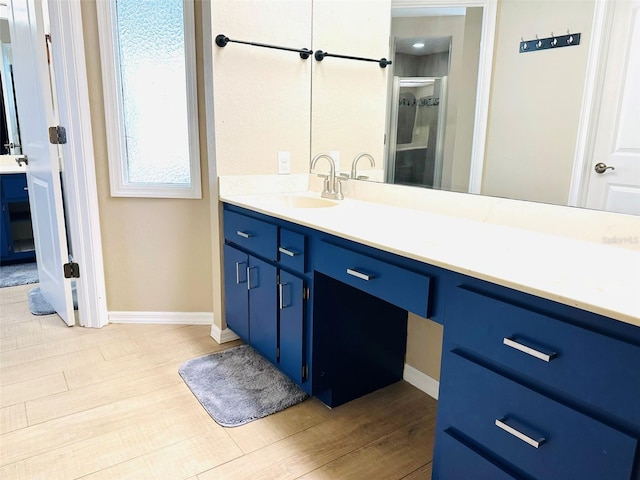 bathroom with hardwood / wood-style flooring and vanity