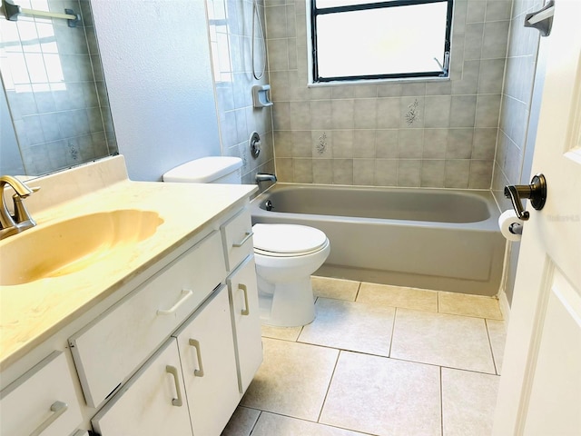 full bathroom with tile patterned floors, vanity, toilet, and tiled shower / bath combo