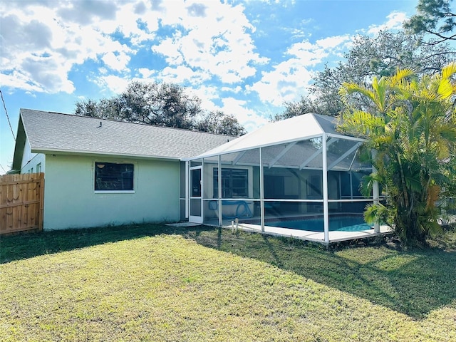 back of house with a fenced in pool, glass enclosure, and a lawn