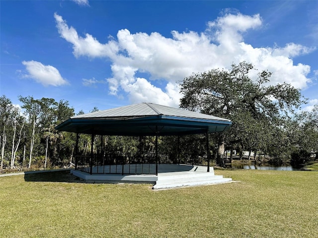 surrounding community featuring a yard, a gazebo, and a water view