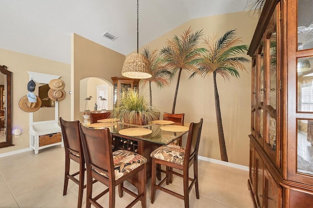 dining room featuring lofted ceiling and light tile patterned floors