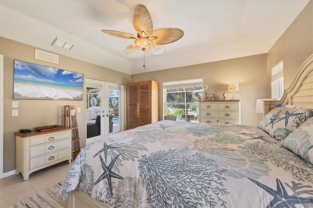 bedroom with light tile patterned floors, ceiling fan, access to exterior, a tray ceiling, and french doors