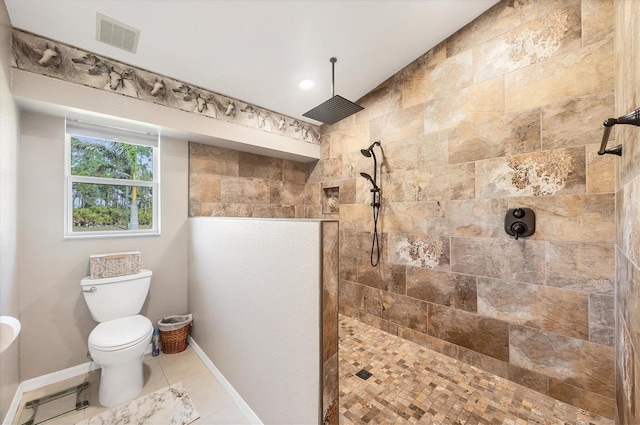 bathroom with a tile shower, tile patterned floors, and toilet