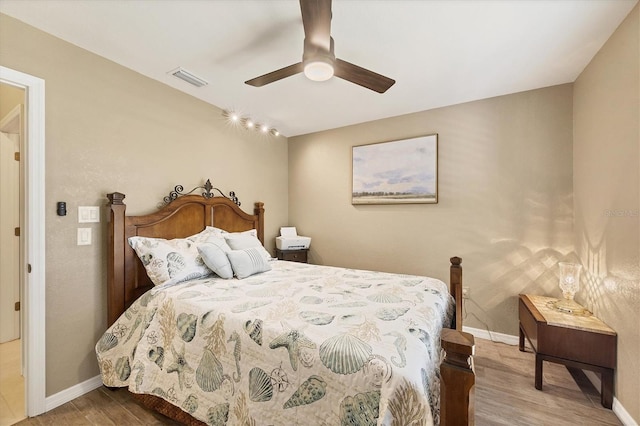 bedroom featuring hardwood / wood-style flooring and ceiling fan