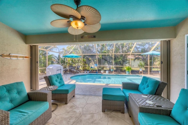 sunroom / solarium featuring ceiling fan