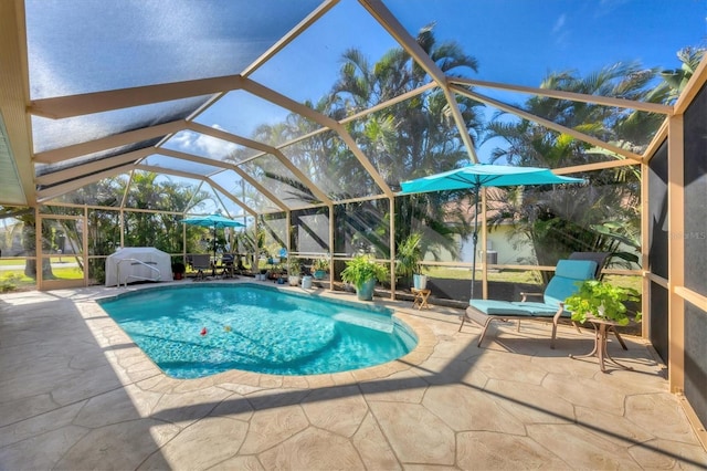 view of swimming pool with a patio, a lanai, and a grill