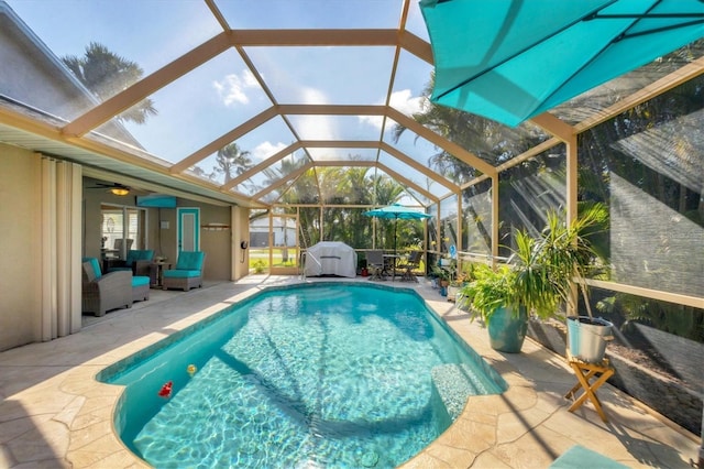 view of pool featuring a patio, a lanai, and ceiling fan