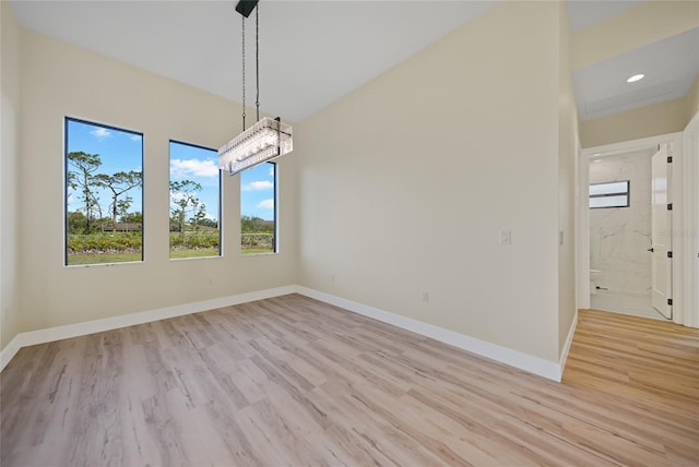 unfurnished dining area featuring light wood-type flooring