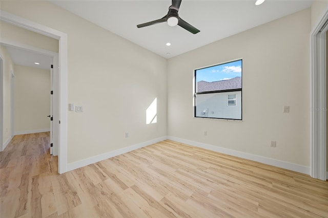 spare room featuring ceiling fan and light wood-type flooring