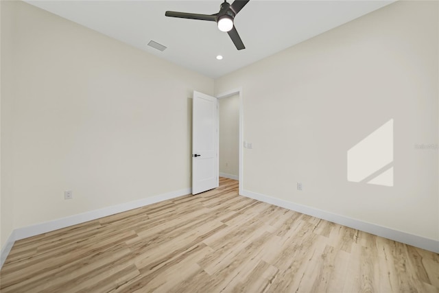 spare room with ceiling fan and light hardwood / wood-style flooring