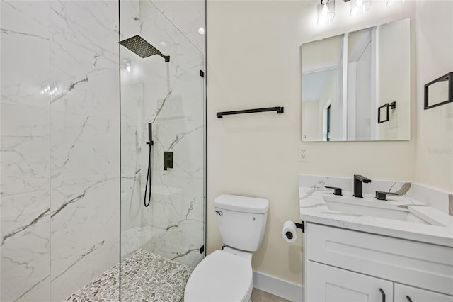 bathroom with vanity, toilet, and a tile shower