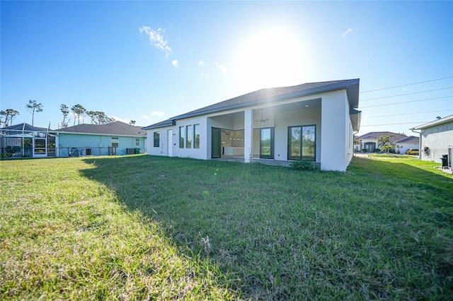 rear view of property featuring a yard