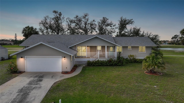 single story home featuring concrete driveway, roof with shingles, an attached garage, covered porch, and a yard