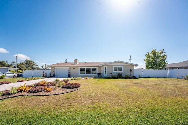 ranch-style house featuring a garage and a front yard