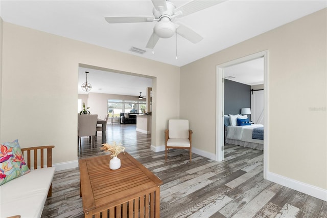 1313 Buereau Rd, Englewood, FL 34223 - living room with wood finished floors, visible vents, baseboards, and ceiling fan