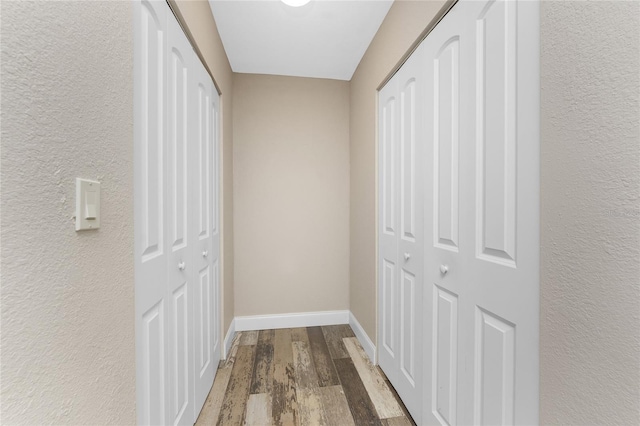 1313 Buereau Rd, Englewood, FL 34223 - hallway featuring wood finished floors, baseboards, and a textured wall