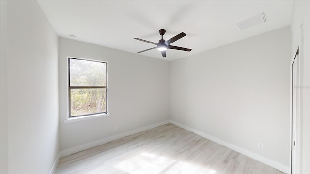 empty room with ceiling fan and light hardwood / wood-style floors