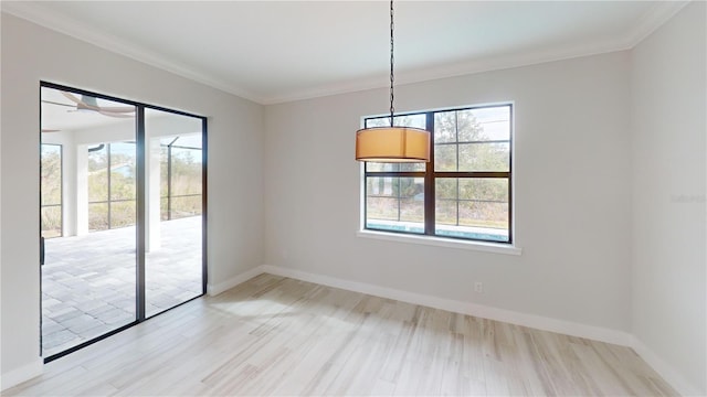 empty room with ornamental molding and light hardwood / wood-style flooring