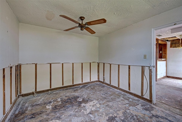 spare room featuring a textured ceiling and a ceiling fan