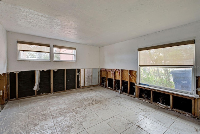 spare room with a textured ceiling