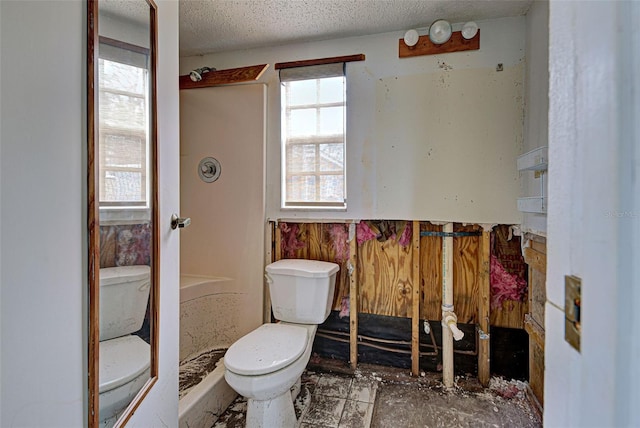 bathroom with a shower, a textured ceiling, and toilet