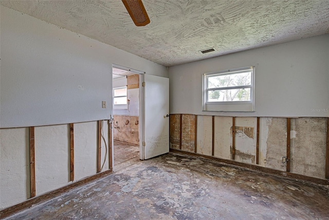 unfurnished room featuring ceiling fan and visible vents