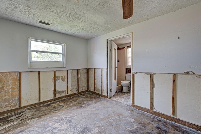 empty room with a textured ceiling and visible vents