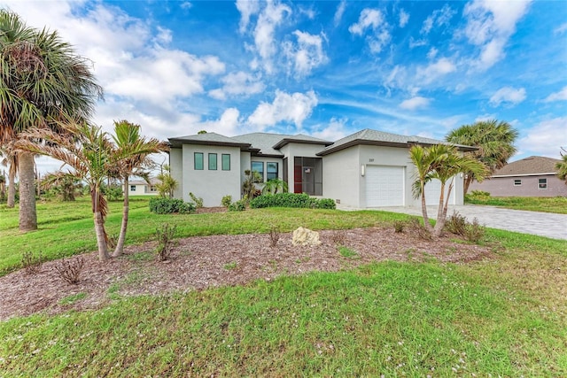 view of front of property featuring a front lawn and a garage