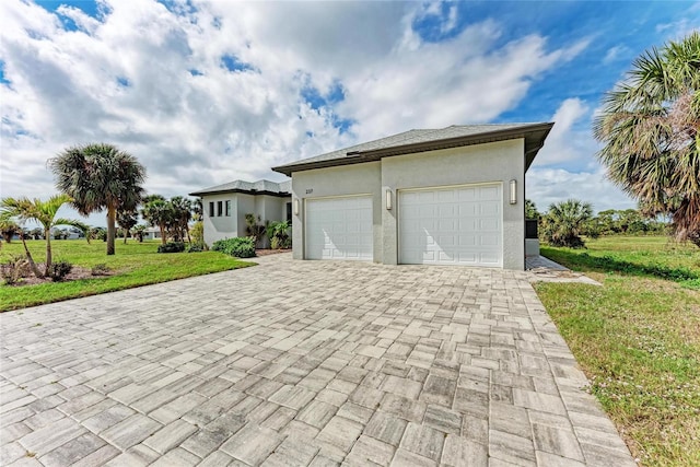 exterior space with a front yard and a garage