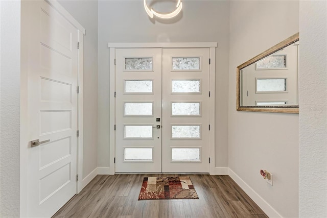 foyer with french doors and hardwood / wood-style floors