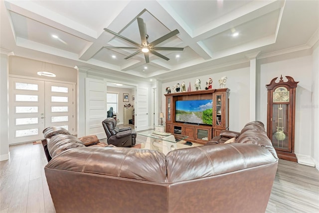 living room featuring coffered ceiling, french doors, light hardwood / wood-style floors, and beam ceiling