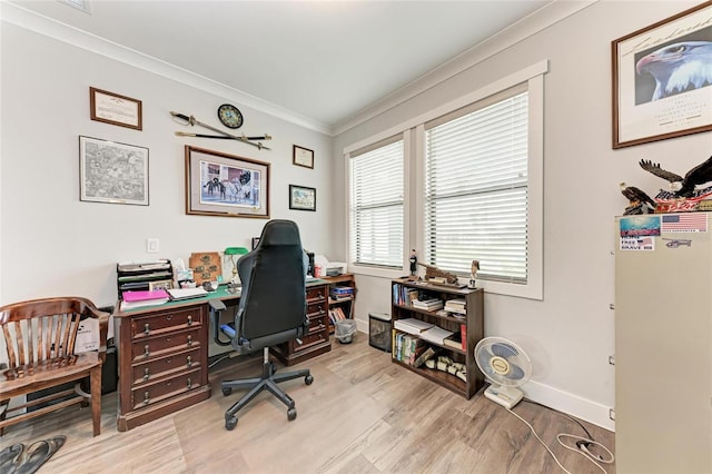 office area with ornamental molding and light hardwood / wood-style floors