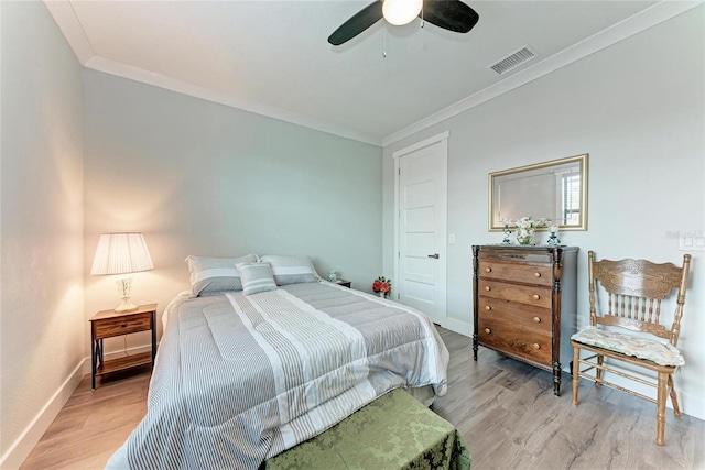 bedroom with light wood-type flooring, ceiling fan, and ornamental molding