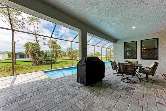 view of pool with a patio area, a lanai, and grilling area