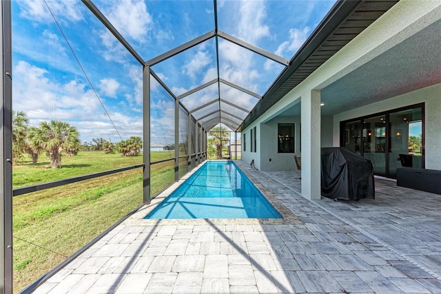 view of pool with a patio, a lanai, and a lawn