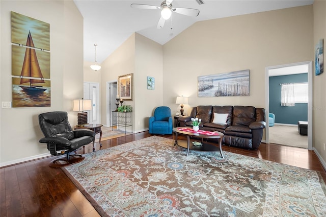 living room featuring dark hardwood / wood-style flooring, high vaulted ceiling, and ceiling fan