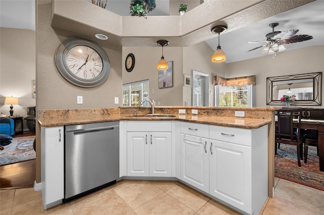 kitchen featuring sink, white cabinetry, dishwasher, stone counters, and pendant lighting